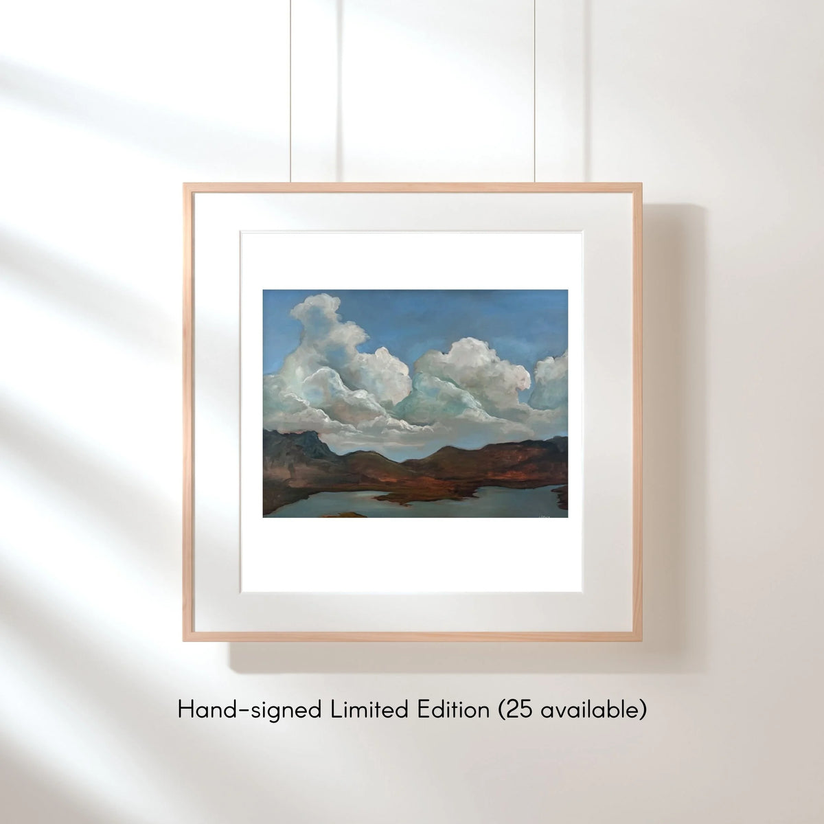 Framed Serenity fine art print by Janine Crum, with towering clouds above still water and distant mountains.