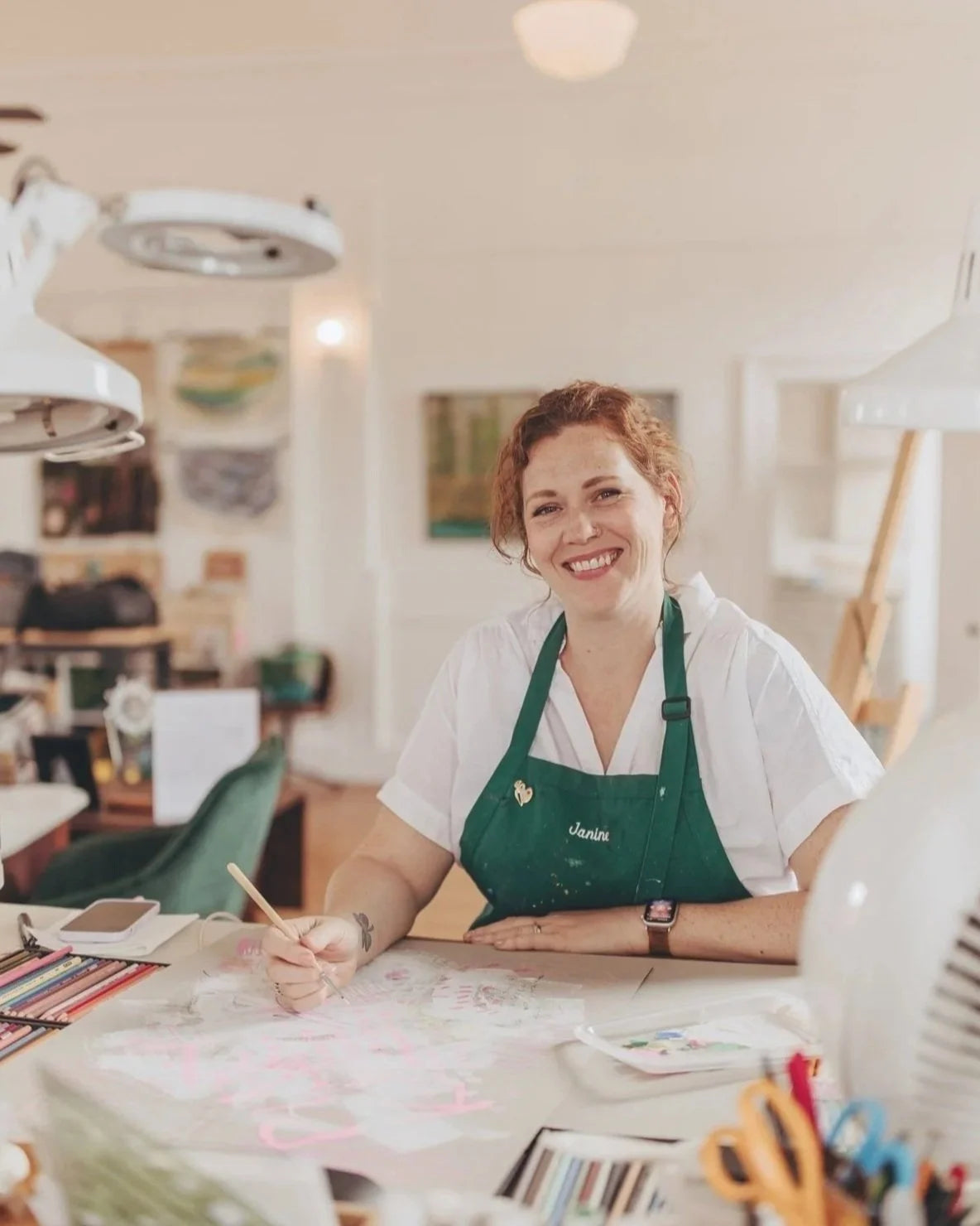 Janine Crum painting in her studio